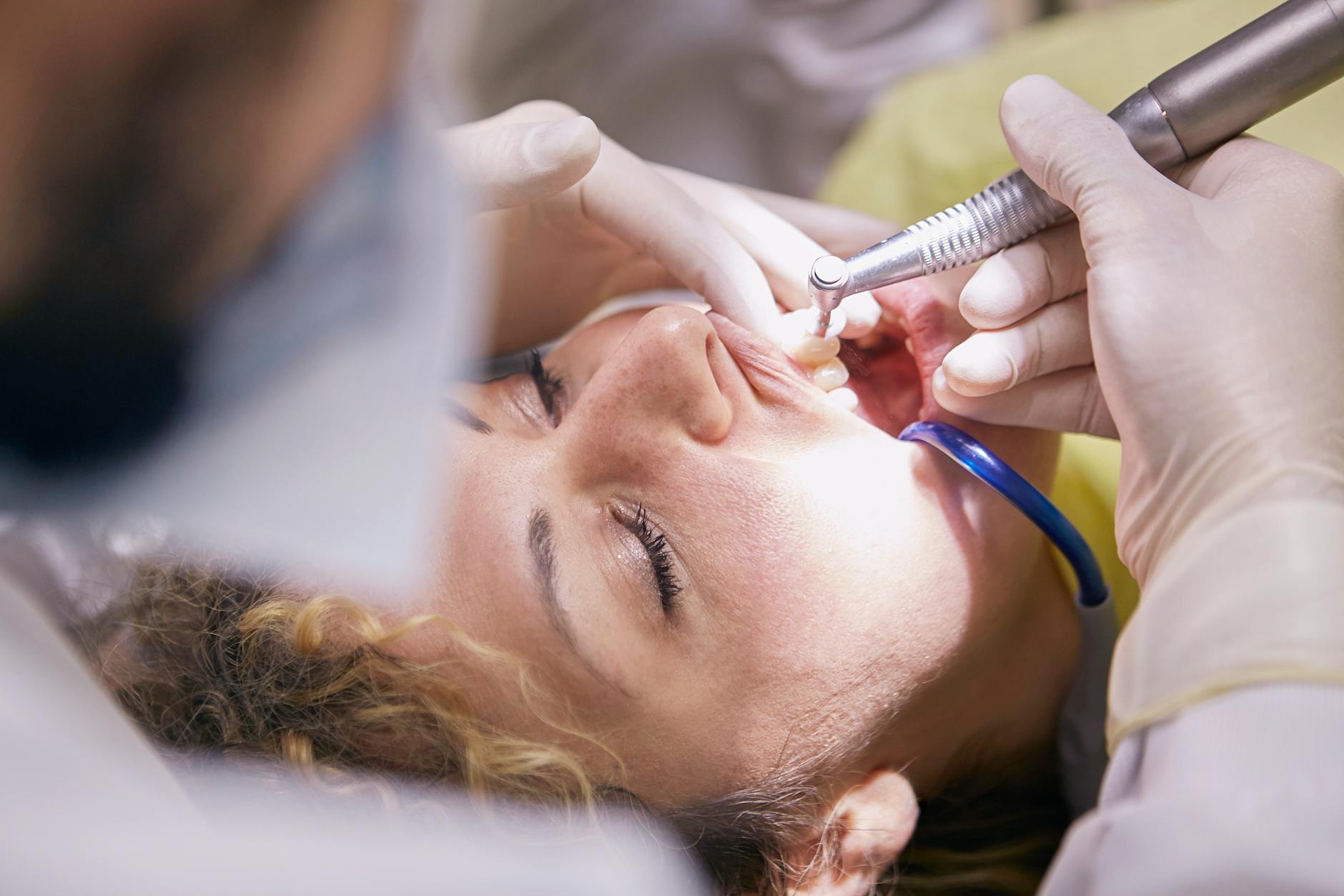 Dentist examining a patient's teeth in a clinic.