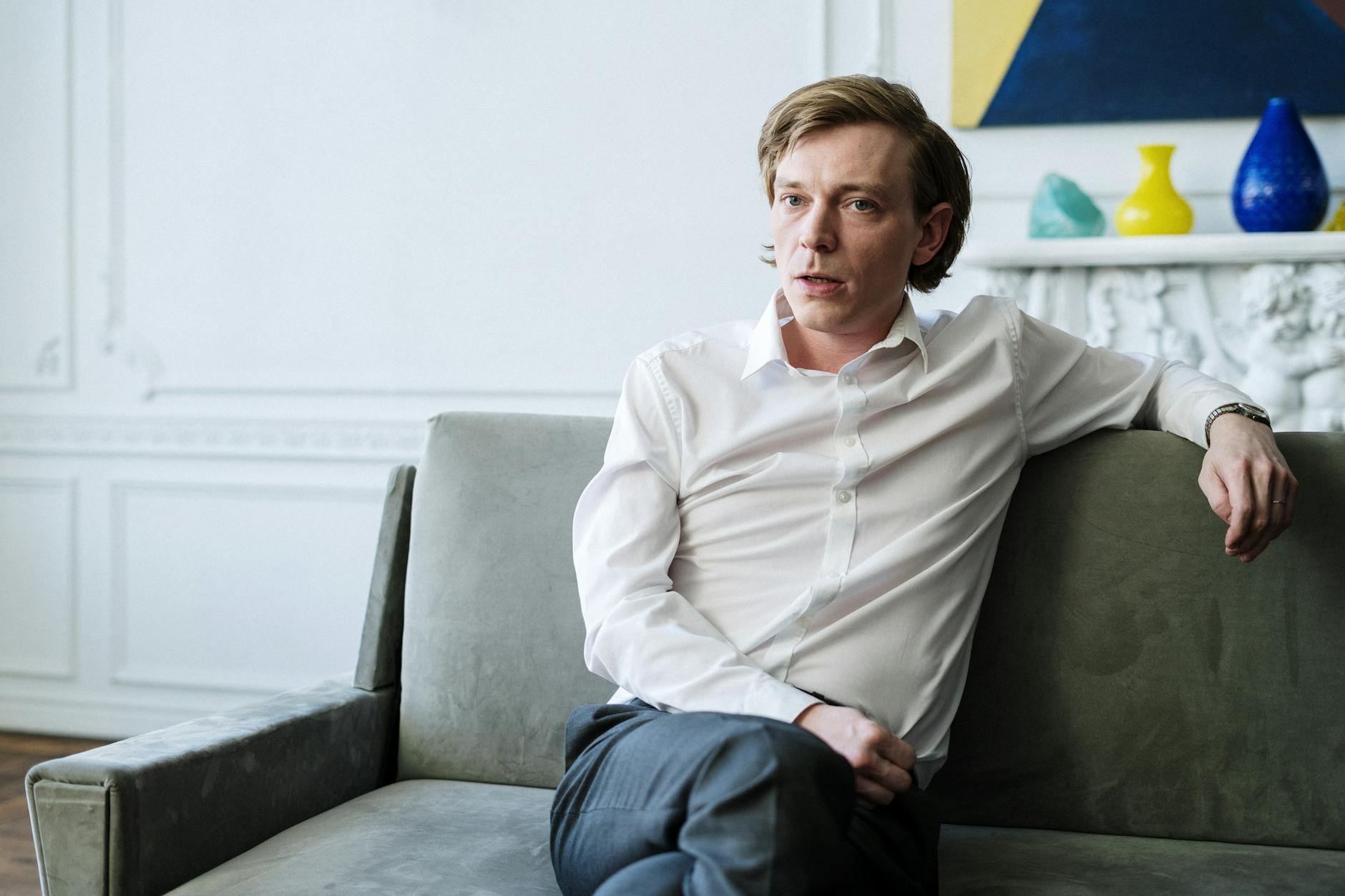 Close-up of a person with a painful expression holding their jaw, indicating signs of tooth infection.