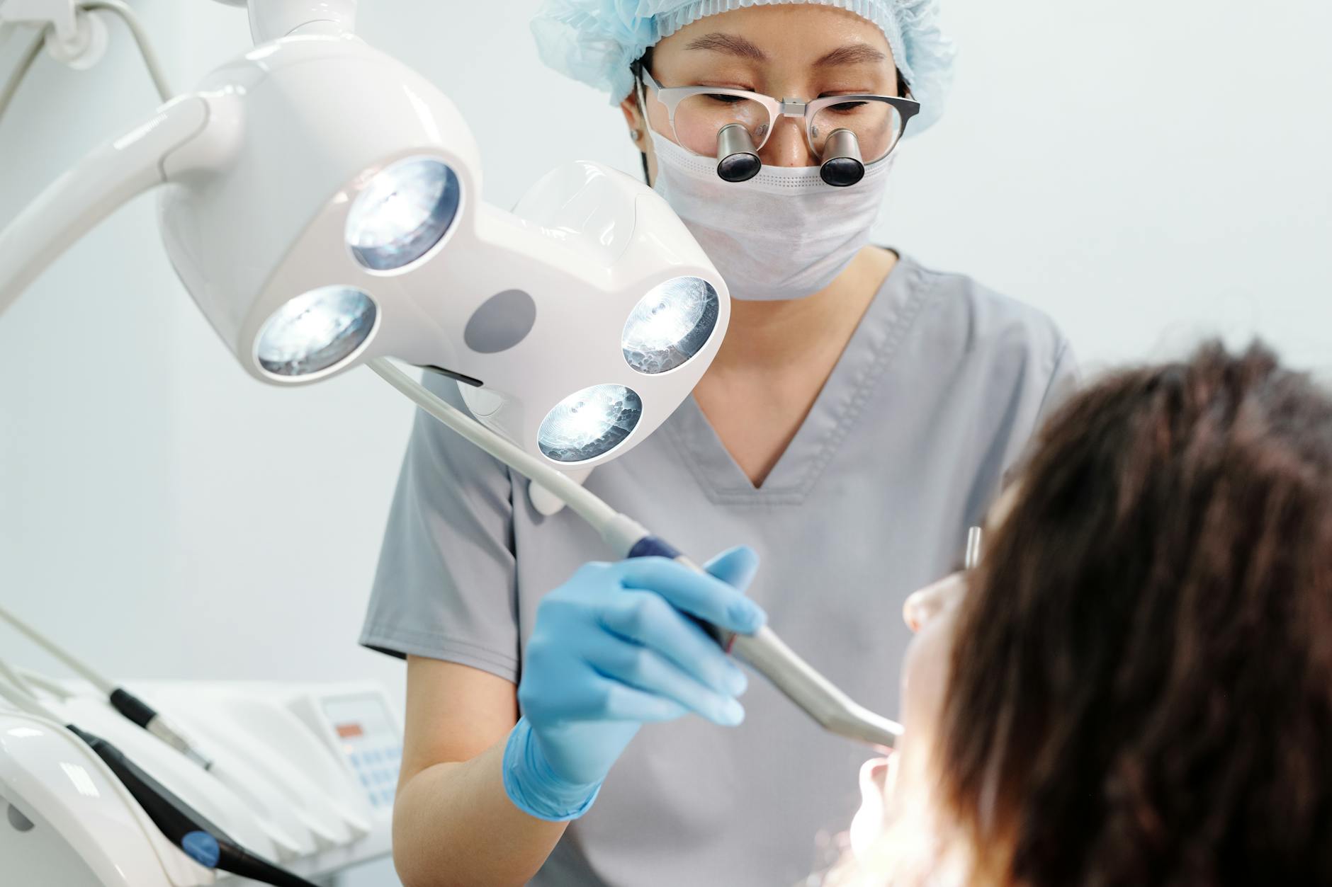 Dentist examining patient's teeth in a clinic setting