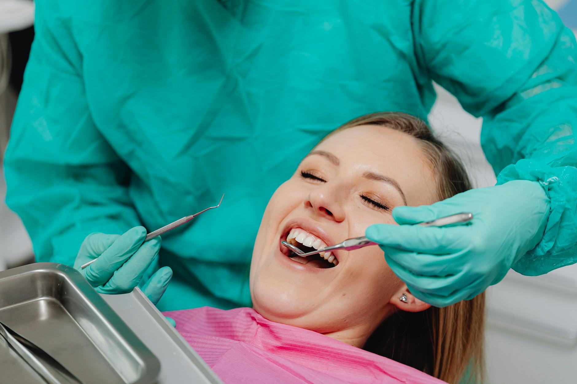 Dentist examining a patient's teeth for emergency dental care