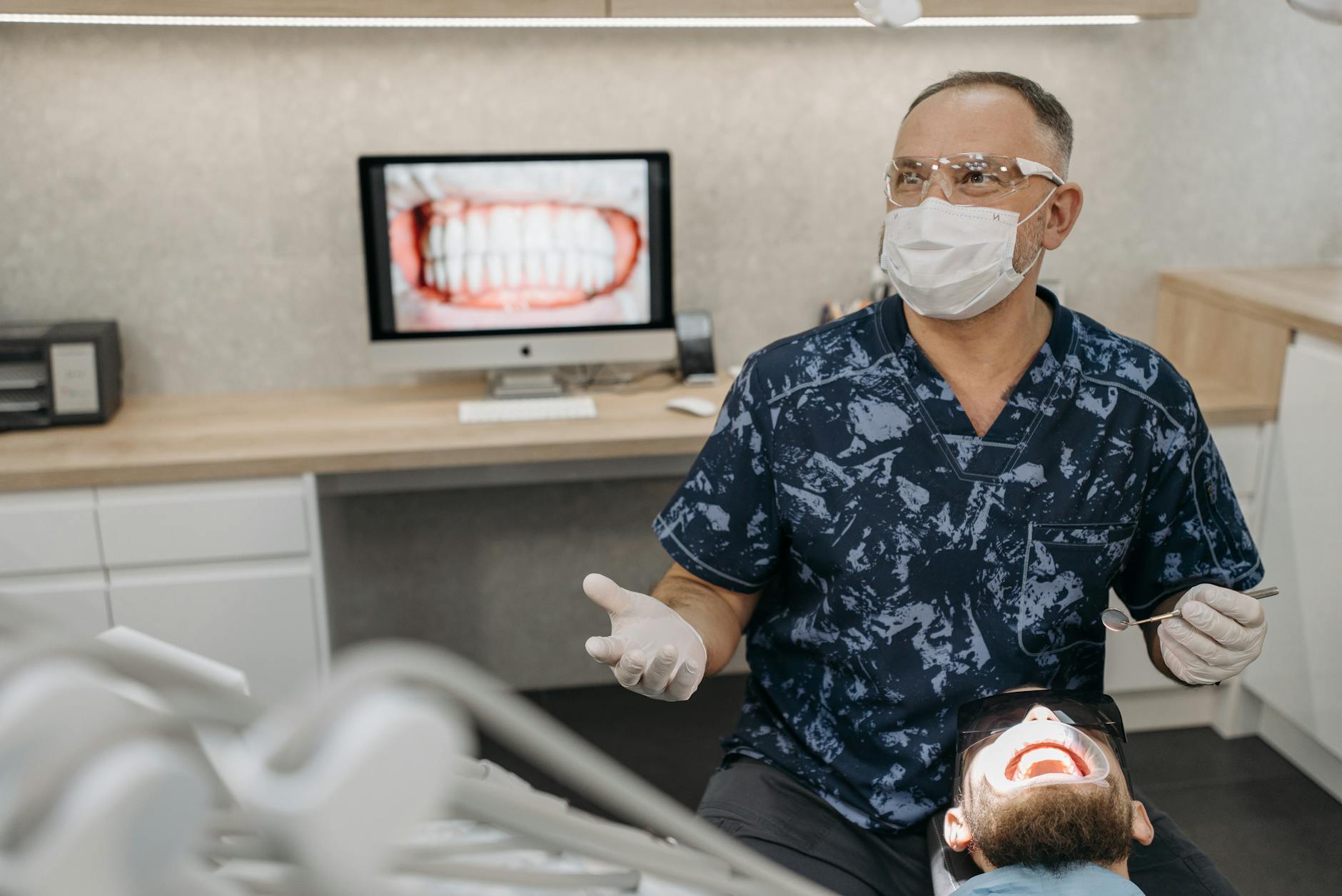 Woman holding an ice pack to her cheek for tooth extraction recovery