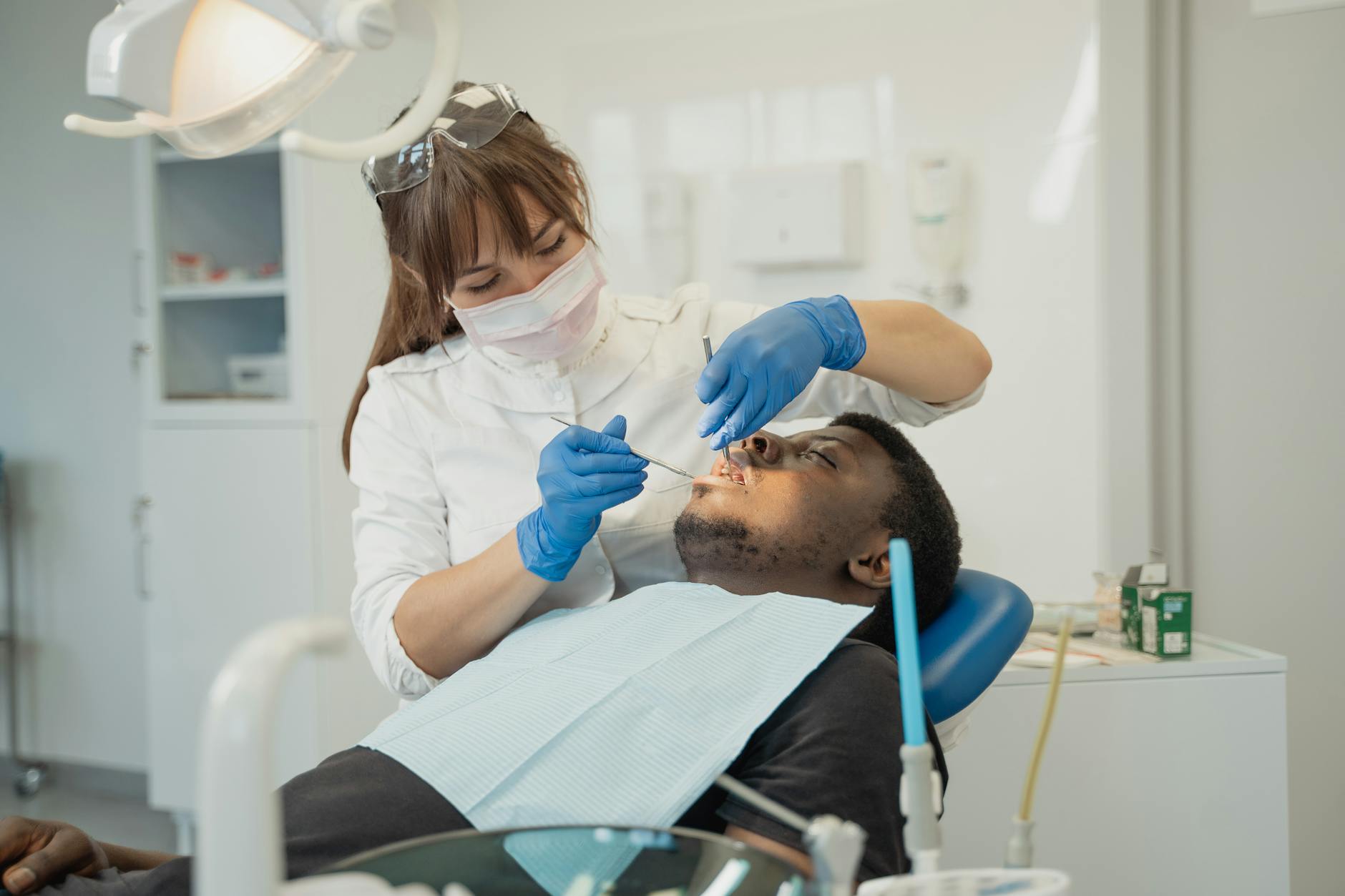 A dentist examining a patient's broken tooth for pain relief.