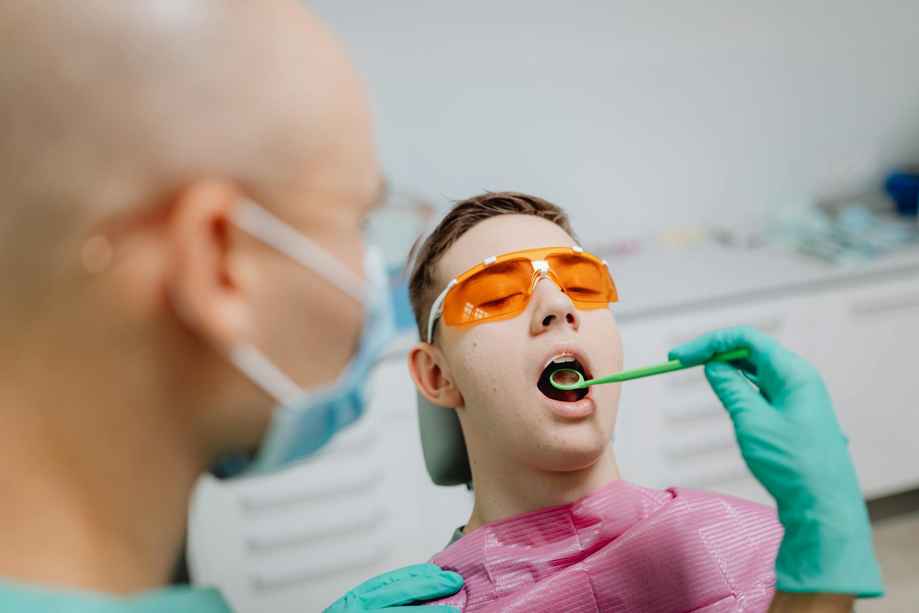 Woman holding her cheek in pain, suggesting tooth pain.