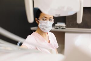 Dentist treating a patient in a dental clinic, relevant to dental abscess dentist visit.