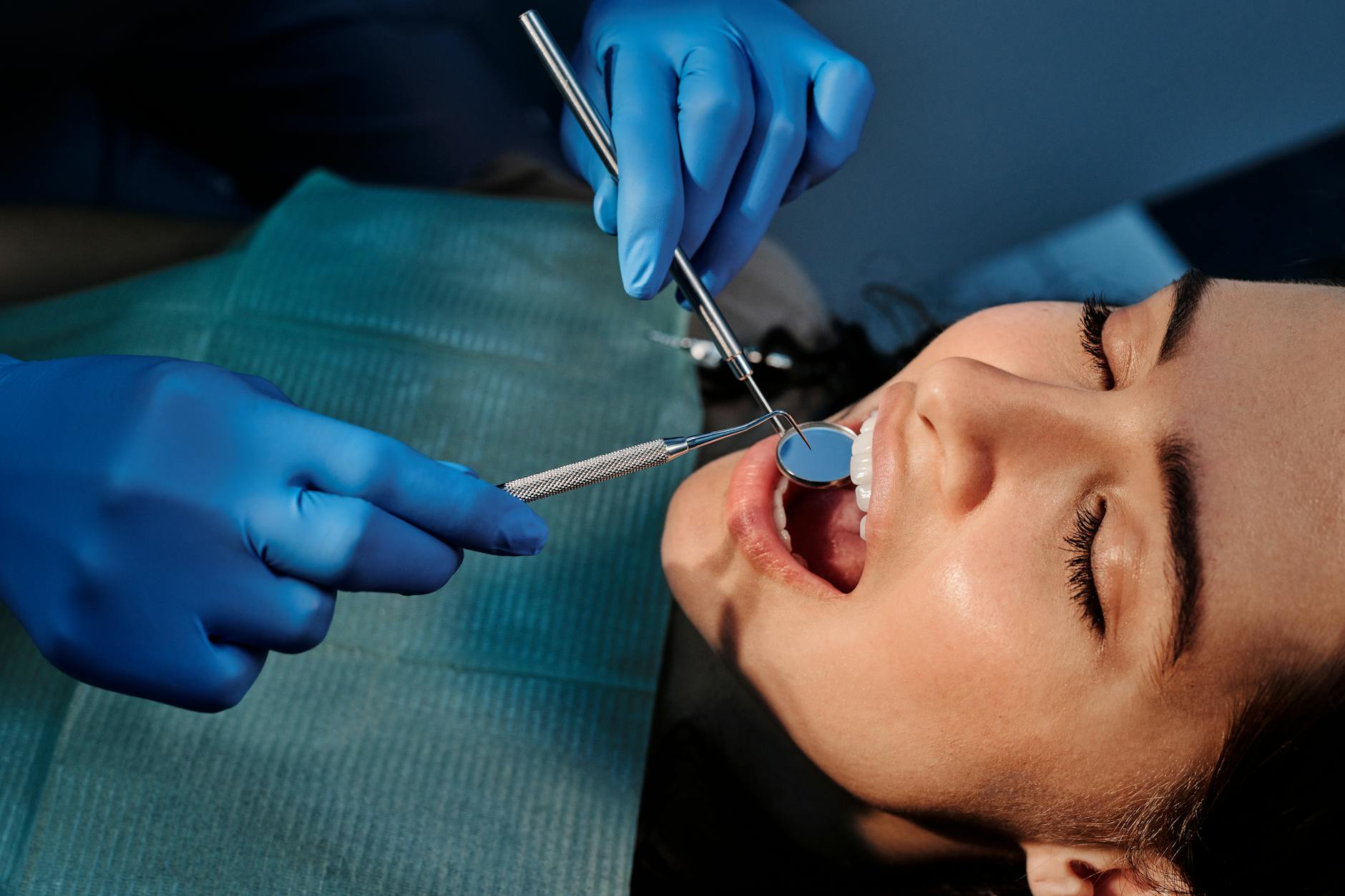 Close-up of a dentist examining a patient's tooth