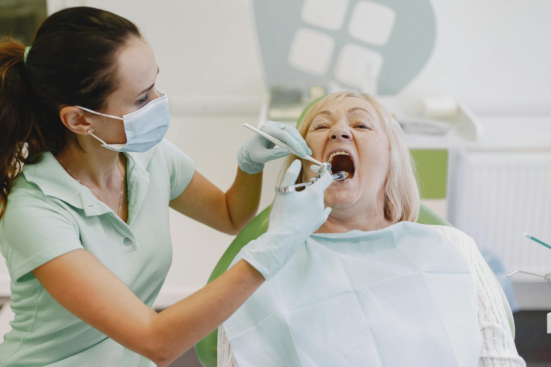 Dentist examining a patient's teeth for cavity tooth pain.