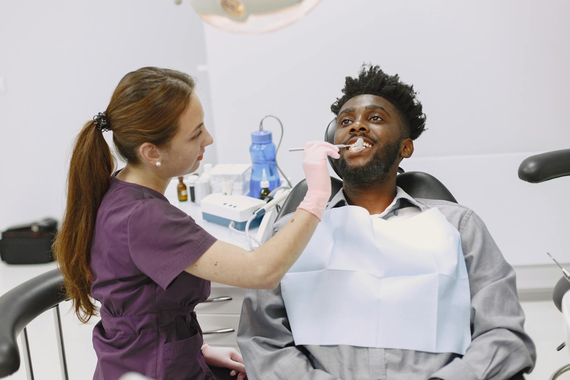 Dentist examining a patient's teeth for a hairline crack