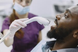 Dentist examining a patient's teeth during a same day appointment