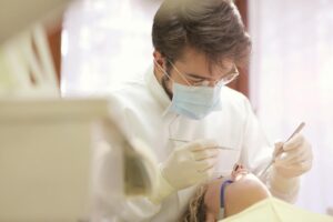 Dentist examining a patient's tooth in a clinic