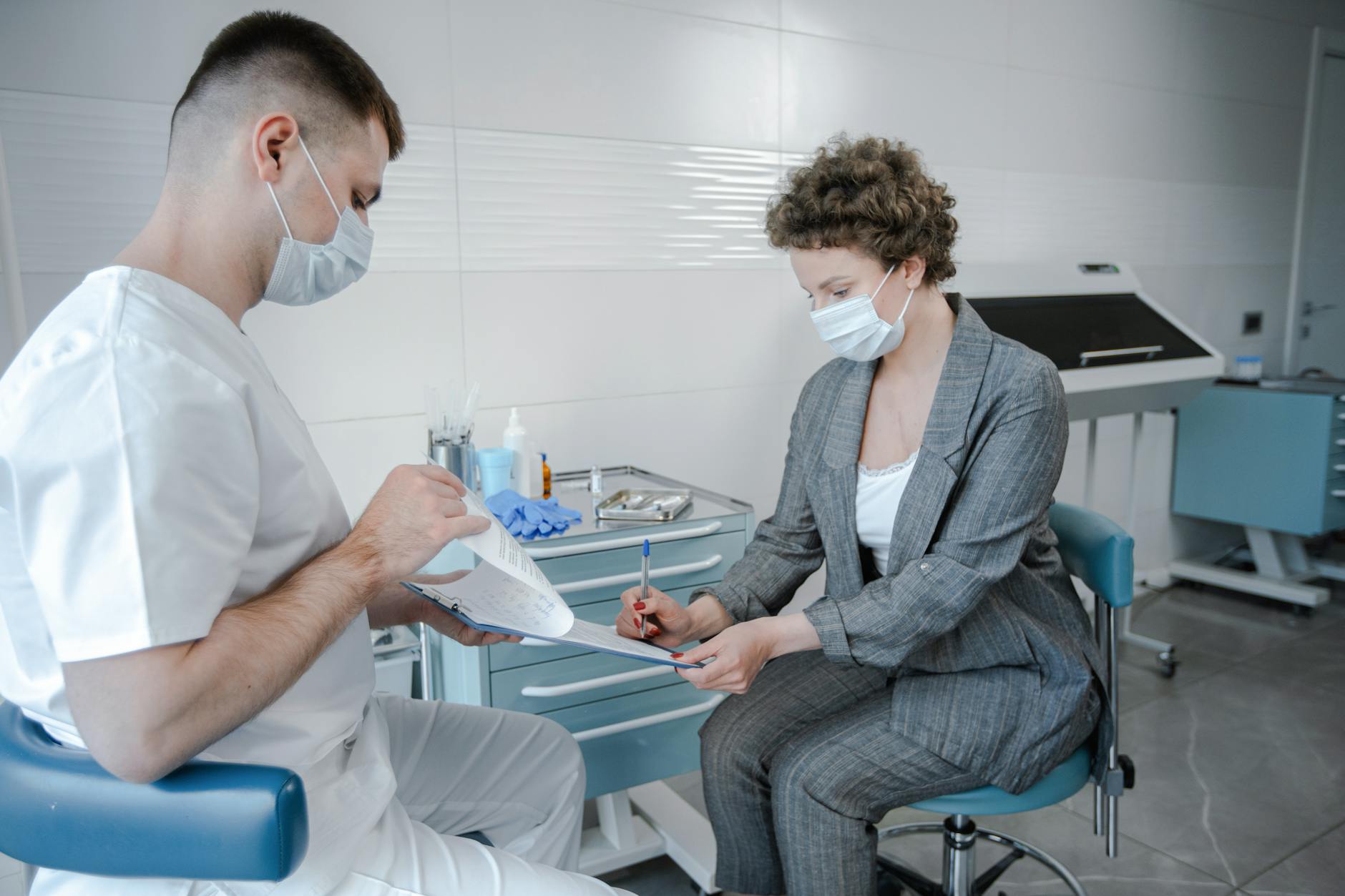 Dentist examining a patient's teeth during a dental check-up.